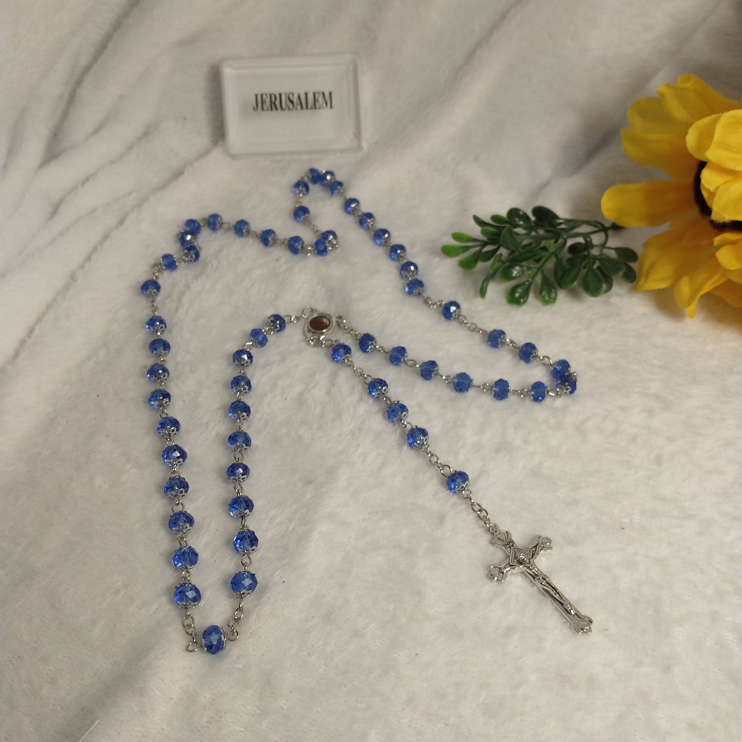 Crystal light blue color with Holy soil from Jerusalem .hand made .this rosary for prayers .first Communion . Baptism